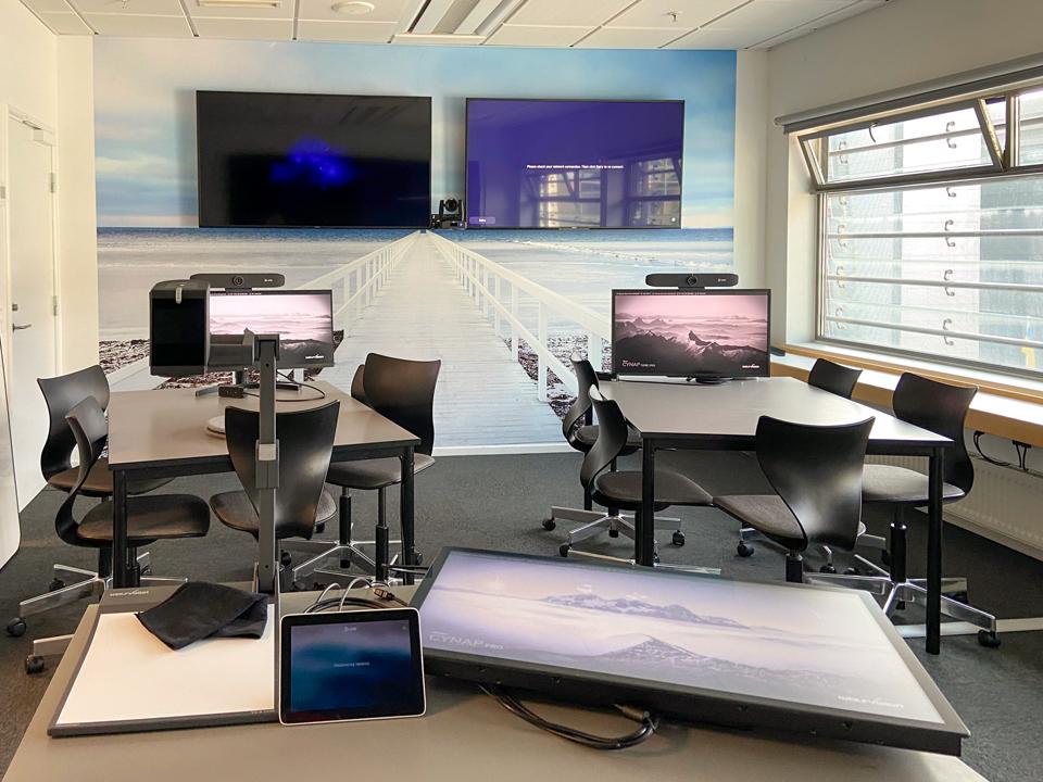 The hybrid learning space is equipped with both large and smaller screens each with their own purpose.